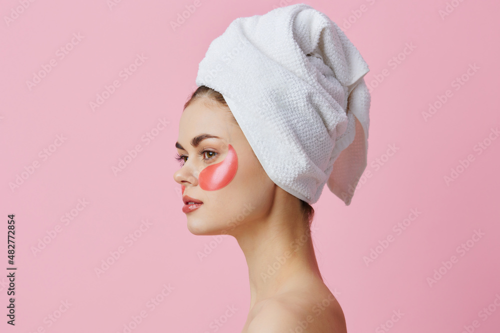 woman pink patches on the face with a towel on the head isolated background woman pink patches on the face with a towel on the head isolated background