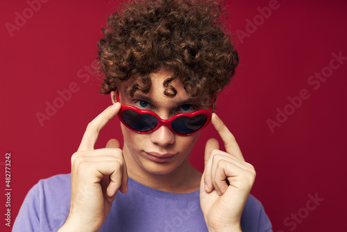guy with red curly hair summer style fashion sunglasses isolated background © Tatiana