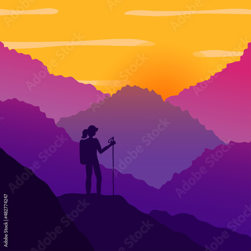Woman hiking in mountains on the sunset