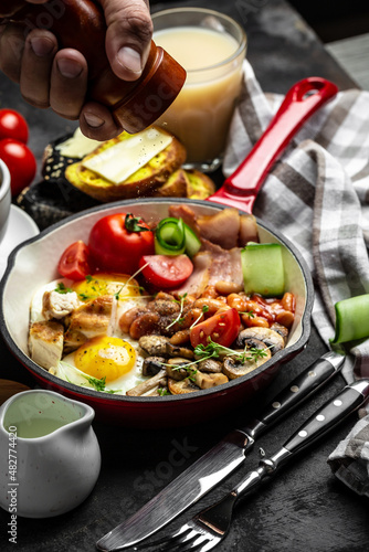 Healthy nutritious paleo keto breakfast diet. Full English breakfast in pan fried eggs, bacon, beans, toasts and coffee. Keto breakfast or lunch. banner, catering menu recipe place for text, top view.