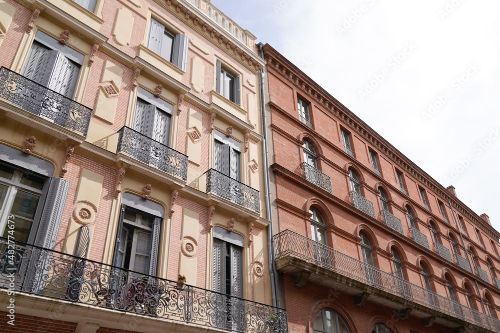 building pink facade street with old buildings in Toulouse building pink facade street with old buildings in Toulouse
