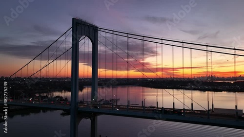 dusk flying clockwise around Bronx Whitestone Bridge with NYC in bkrd photo