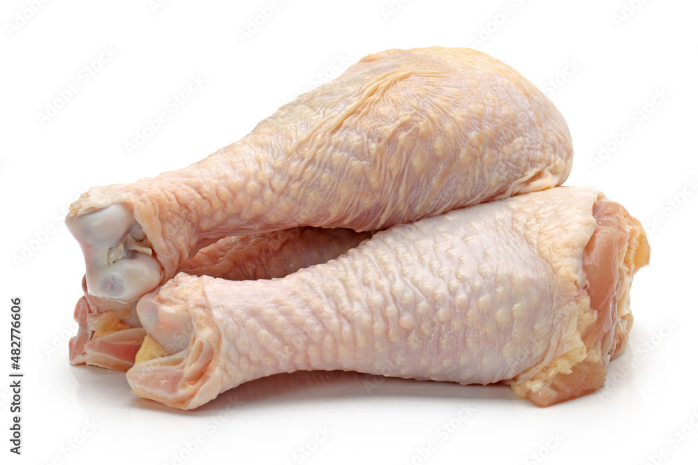 raw chicken legs on white.