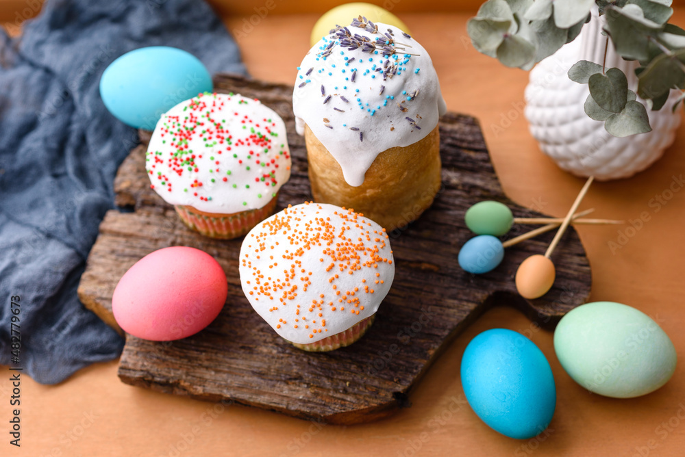 Festive cakes with white glaze, nuts and raisins with Easter eggs on the festive table Festive cakes with white glaze, nuts and raisins with Easter eggs on the festive table
