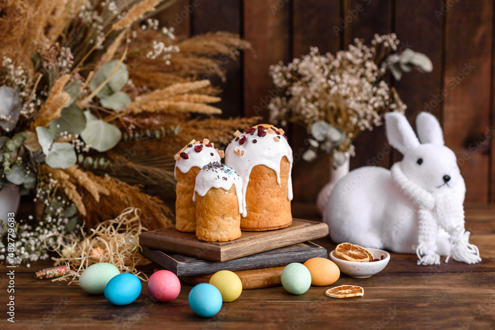 Easter eggs with cake on a brown wooden table Easter eggs with cake on a brown wooden table