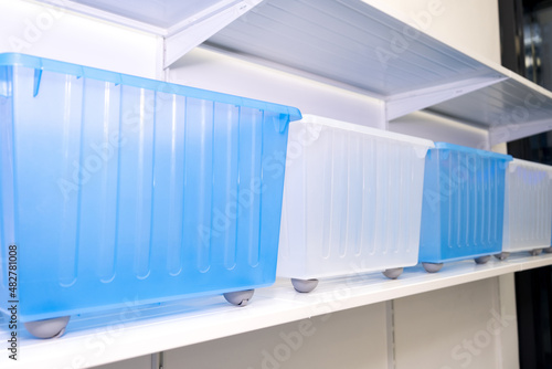 Organization of the space at home, storage of things, a lot of plastic boxes, new container boxes for convenient storage of things.