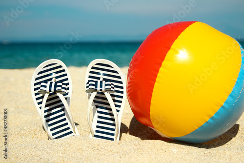 Family slippers on the sand on the beach