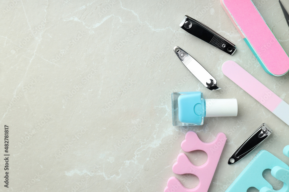 Concept of nail care with manicure accessories on light textured background Concept of nail care with manicure accessories on light textured background