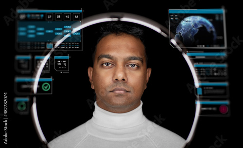 future technology, augmented reality and cyberspace concept - indian man over white illumination with virtual screens projection on black background