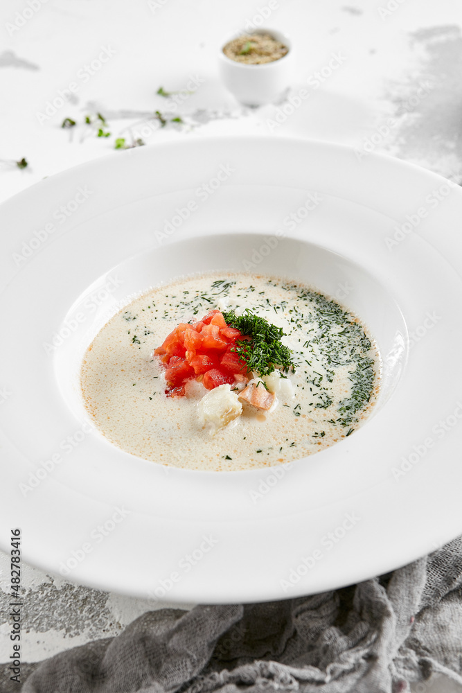 Fish creamy soup in norwegian style. Finnish fish soup with tomato, dill and creamy. Scandinavian food - salmon creamy soup. Seafood chowder with vegetables and fish. Norwegian cuisine. Fish creamy soup in norwegian style. Finnish fish soup with tomato, dill and creamy. Scandinavian food - salmon creamy soup. Seafood chowder with vegetables and fish. Norwegian cuisine.
