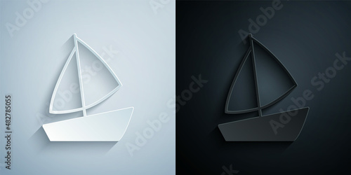 Paper cut Yacht sailboat or sailing ship icon isolated on grey and black background. Sail boat marine cruise travel. Paper art style. Vector