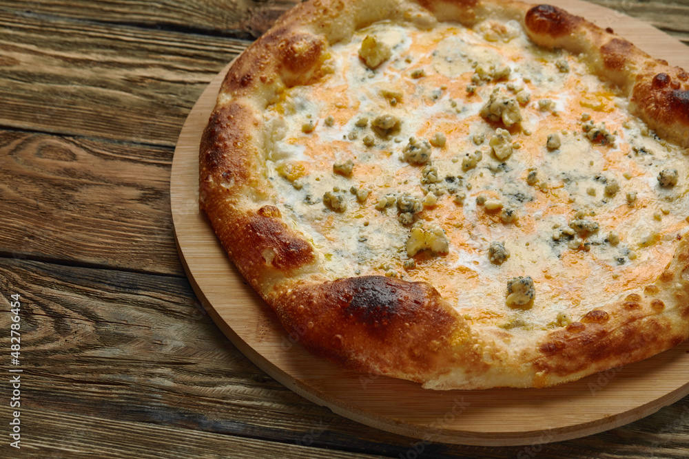 Italian Pizza Quattro formaggi. Italian pizza on wooden background Italian Pizza Quattro formaggi. Italian pizza on wooden background