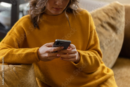 Girl working at home with a phone during quarantine