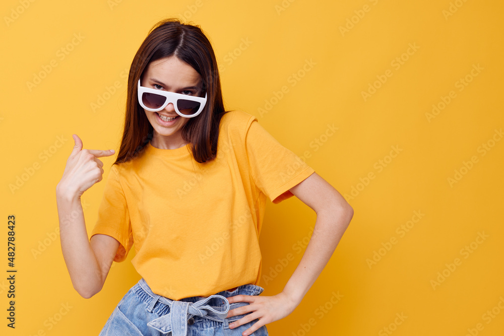 young beautiful woman fashion in yellow t-shirt denim shorts yellow background young beautiful woman fashion in yellow t-shirt denim shorts yellow background