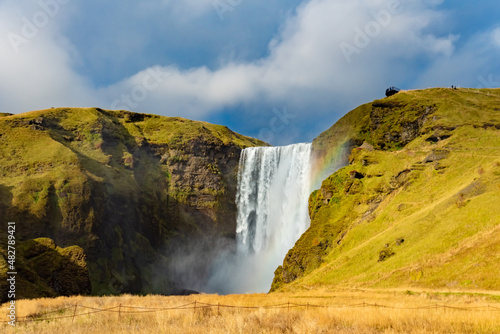 Skogafoss waterfall and rainbow, Iceland landmark. Sunny weather
