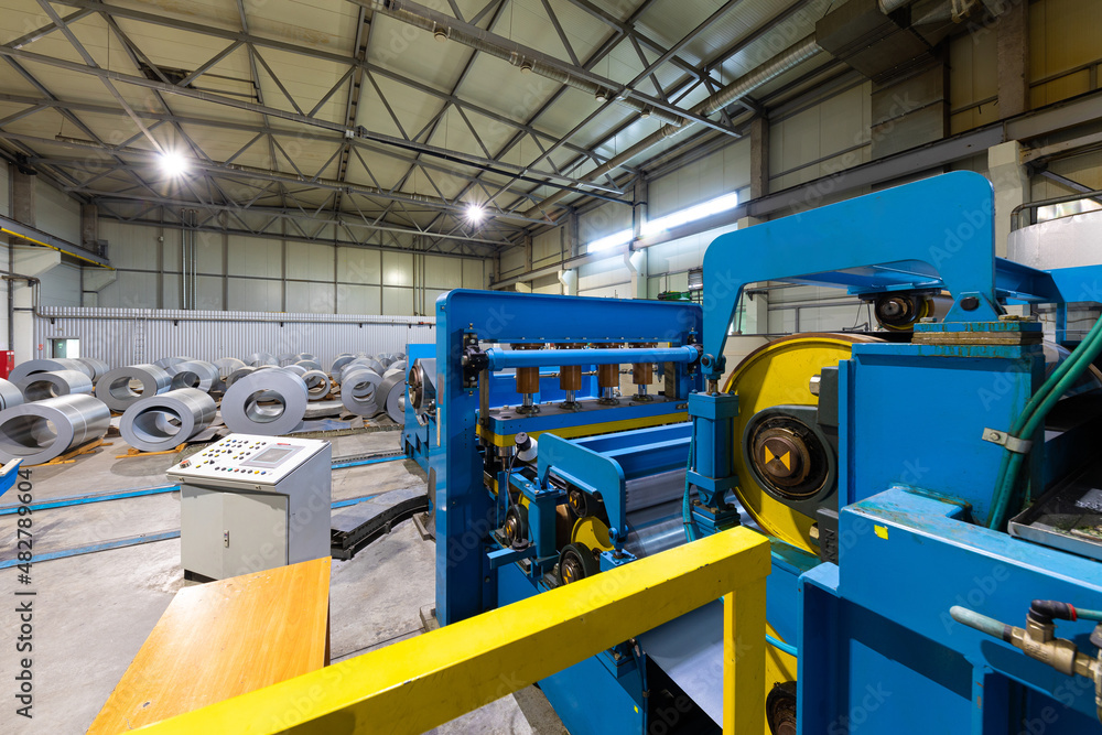 Naklejka premium Production line of metal tile for roof. Steel forming machine in metalwork factory workshop