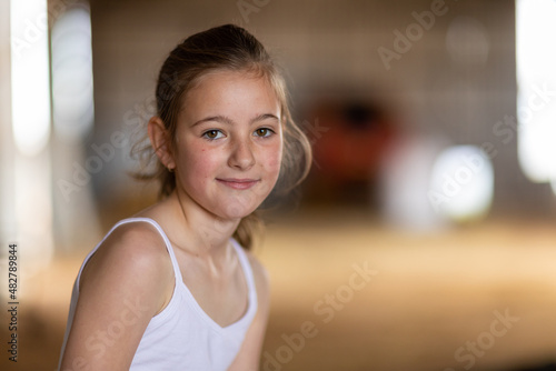 head and shoulders of brown-eyed young girl with blurry backgrund photo