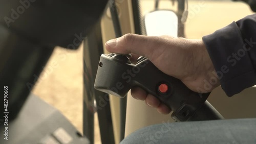 Male Hands Farmer Driver On joystick Combine Harvest On Agricultural Field. View From Inside.