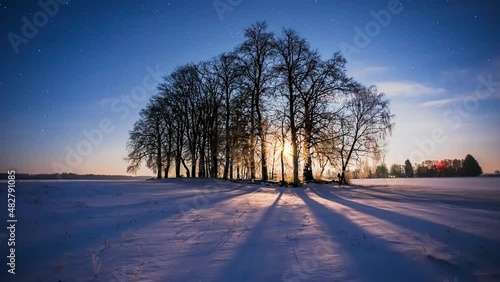 Winter night timelapse of moon shadows moving across the snowy meadow, cold winter night, 4k timelapse photo