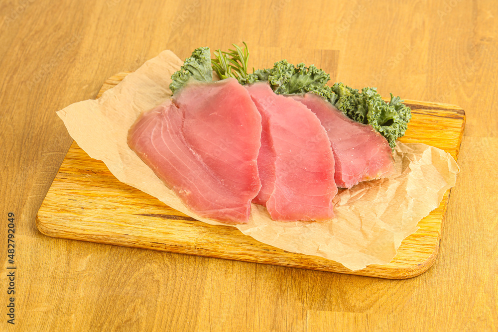 Raw salted tuna slice over board Raw salted tuna slice over board