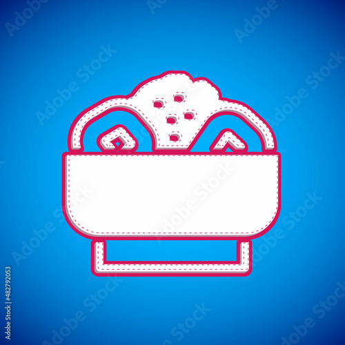 White Chow mein on plate icon isolated on blue background. Asian food. Vector