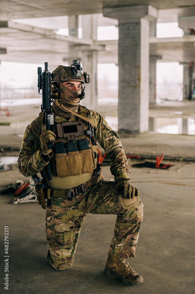 Special forces operator wearing Multicam uniform and his assault rifle ...
