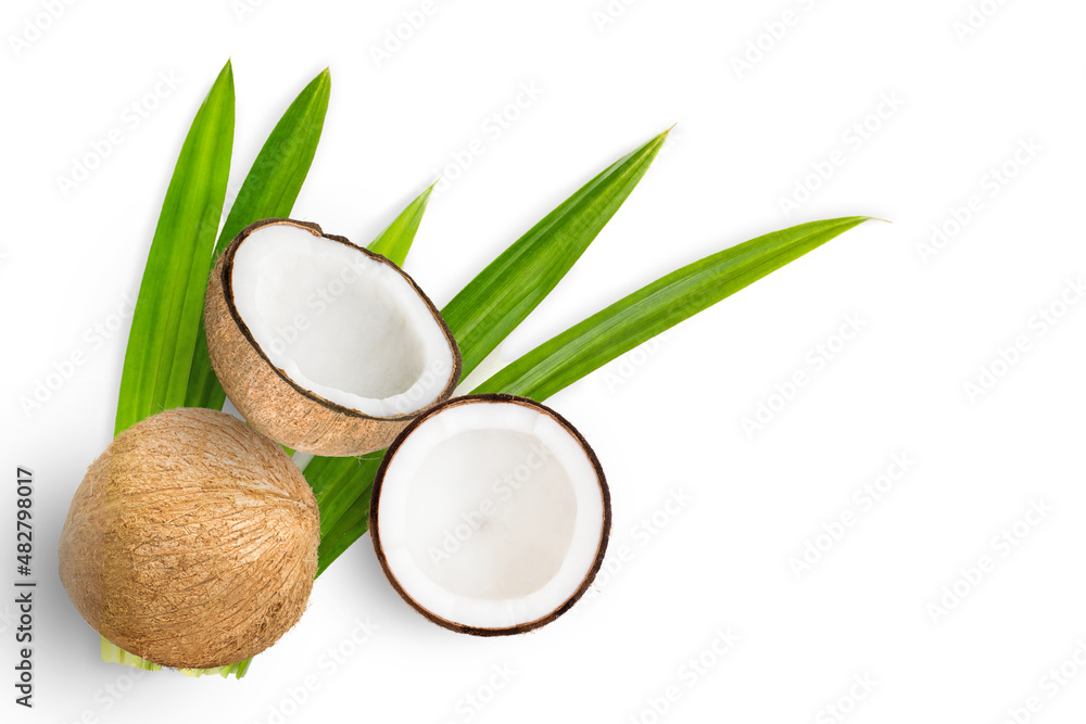 Coconut fruit and half slices with green leaves isolated on white background. Top view. Flat lay.