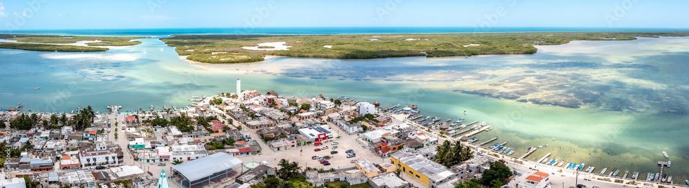 Aerial landscape overlooking the city of Rio Lagartos. The city is surrounded by a beautiful river with azure water. Fishing boats are moored to the shore. Yucatan, Mexico