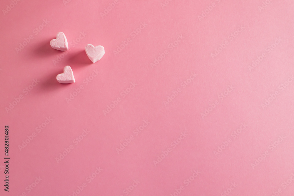 Heart made of marshmallows on a pink background. Happy Valentine's Day, Mother's Day, 8 March, World Women's Day. Copy space. The concept of holidays and love. Flatlay. Top view.