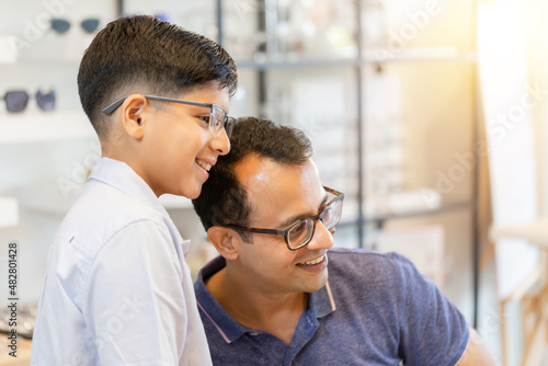 Indian father and son choosing eyeglasses in optics store © JU.STOCKER