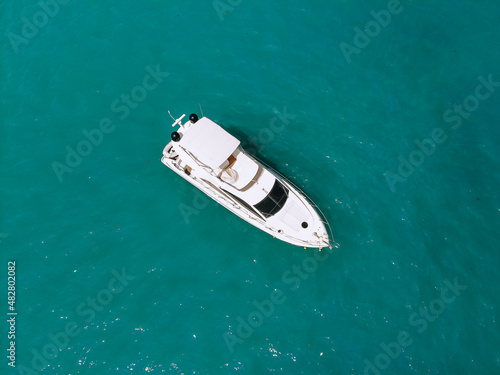 Adorable aerial top view photo of a laxury huge two-storey yach sailing across the deep blue sea
