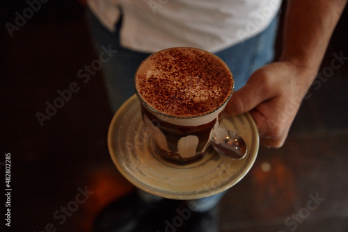 Waiter serving coffee