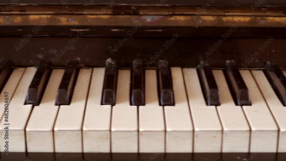 Close-up of shiny black and white old piano keys with golden brass edge reflection with shallow depth of field. slider.. 4k Close-up of shiny black and white old piano keys with golden brass edge reflection with shallow depth of field. slider.. 4k