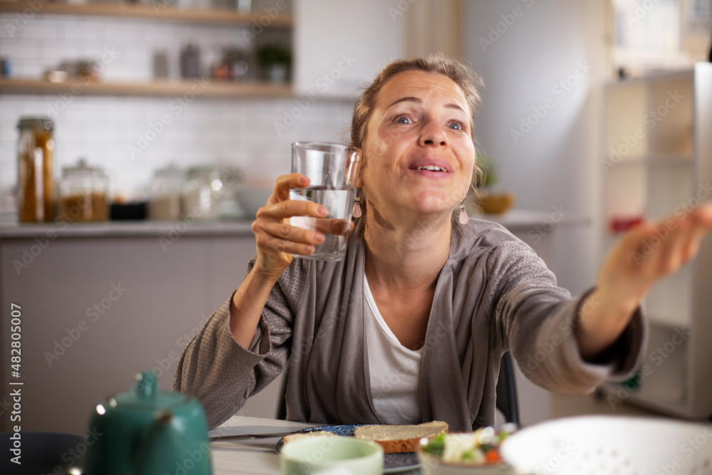 Beautiful woman enjoying in breakfast. Happy young woman eating sandwich at home... Beautiful woman enjoying in breakfast. Happy young woman eating sandwich at home...