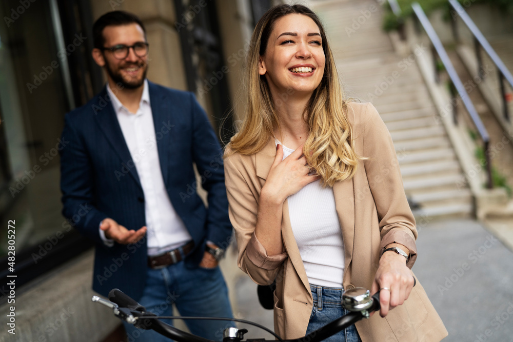 Young businesswoman and businessman standing on the street Beautiful businesswoman with bicycle..