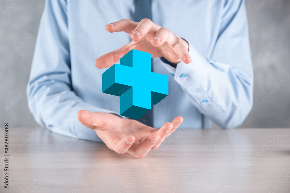 Businessman hold 3D plus icon, man hold in hand offer positive thing such as profit, benefits, development, CSR represented by plus sign.The hand shows the plus sign Businessman hold 3D plus icon, man hold in hand offer positive thing such as profit, benefits, development, CSR represented by plus sign.The hand shows the plus sign