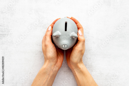 Piggy bank in hands top view. Family budget concept