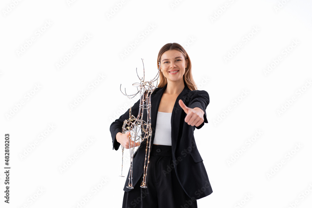 Young business woman holding illuminated Christmas deer decor dressed black suit isolated on white background Young business woman holding illuminated Christmas deer decor dressed black suit isolated on white background