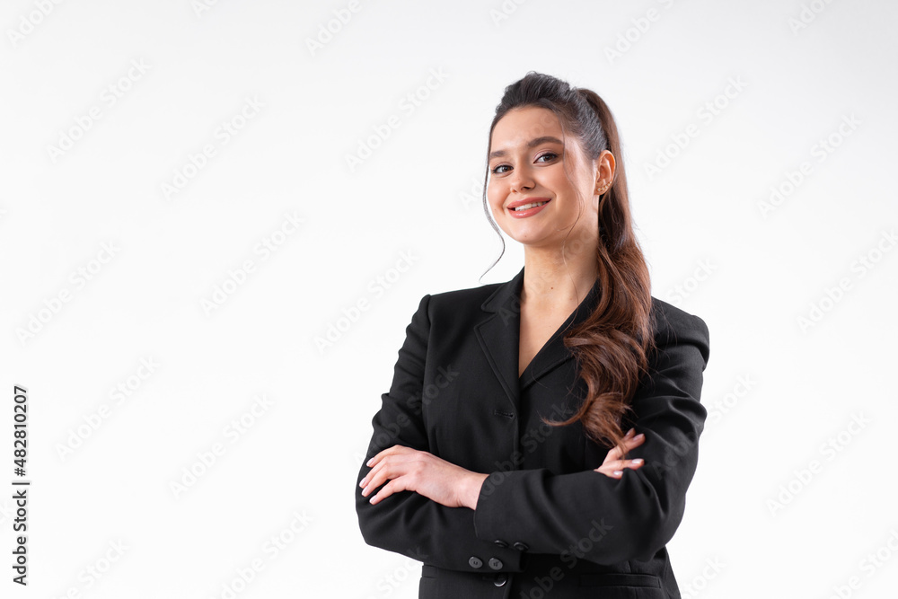 Young business woman arms crossed in black jacket standing studio isolated on white background Young business woman arms crossed in black jacket standing studio isolated on white background
