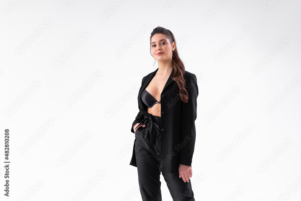 Young business woman arms crossed in black jacket standing studio isolated on white background Young business woman arms crossed in black jacket standing studio isolated on white background