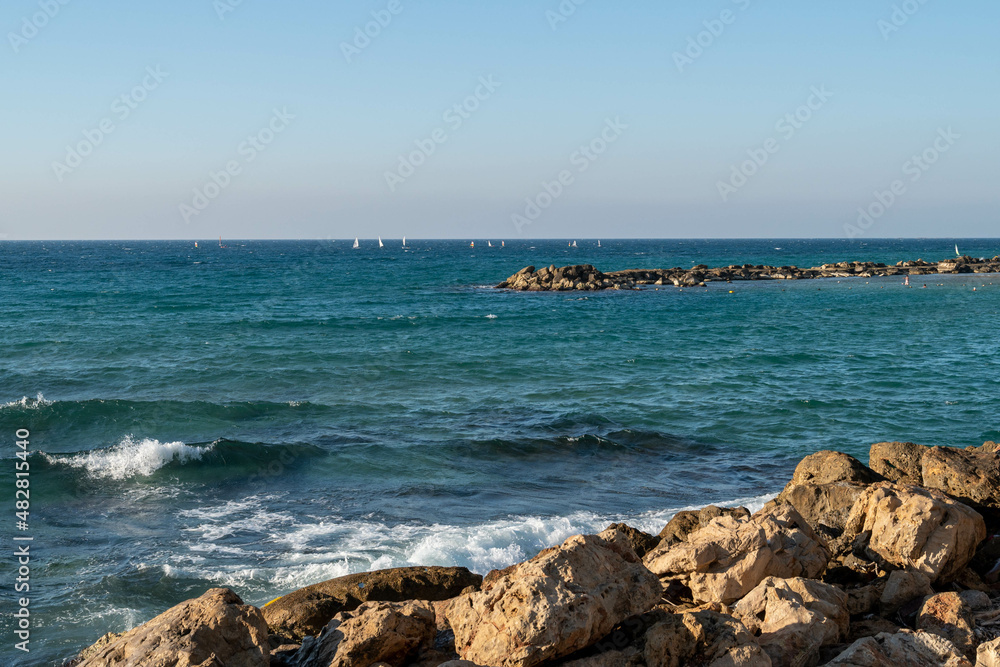 Fototapeta premium Nahariya's Promenade and Galei Galil Beach view of the sea and the shore from the pier