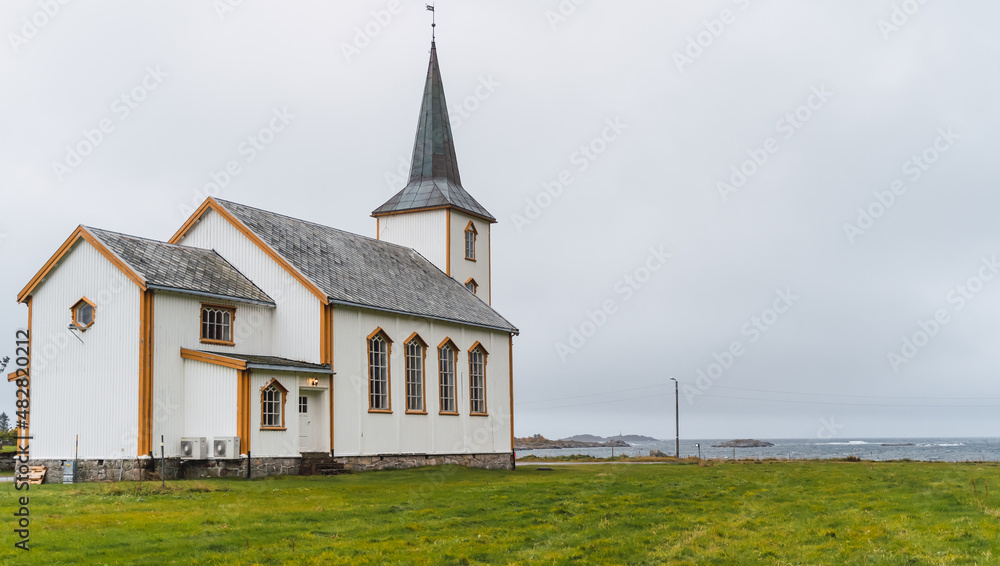 Traditional Norwegian church in front of the beach
