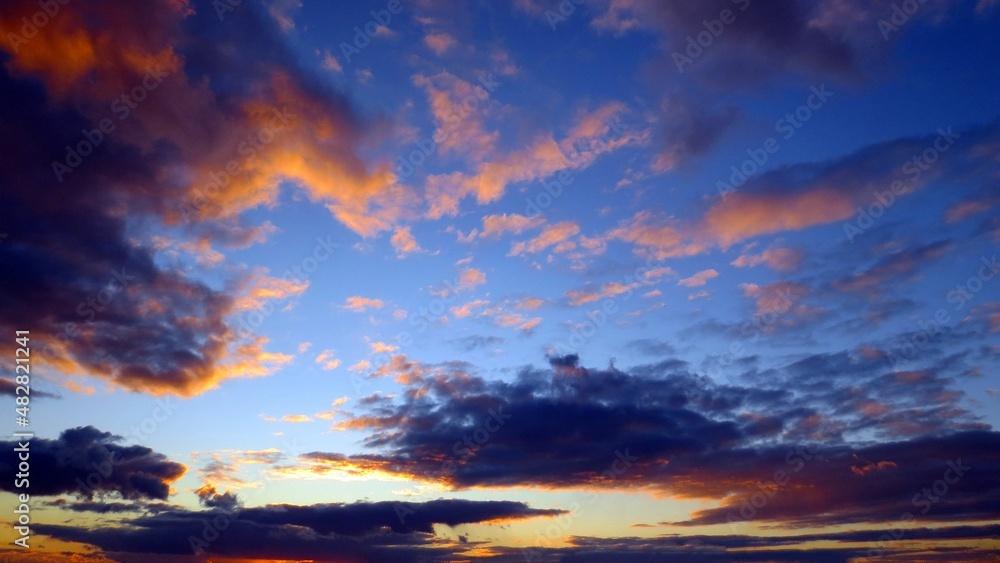 Beautiful sunset from a pink and purple cloud in the sky on a blue background