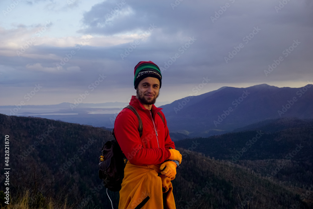 Traveler on top of a mountain at sunset Traveler on top of a mountain at sunset