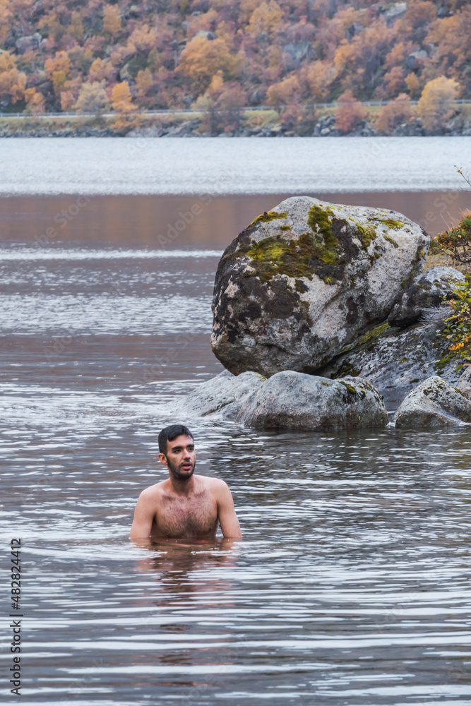 Man bathing in a lake in Norway