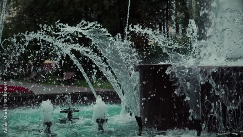 Beautiful asure fountain in the park on a gloomy summer day