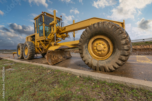 A motor grader at a road construction site