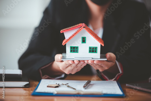 Real estate agent with house plans in hand