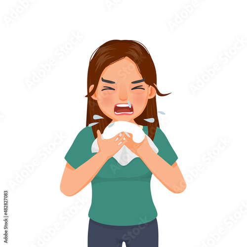 Young woman with runny nose holding a handkerchief or tissue sneezing and blowing because of fever, cold, flu, allergy, virus infection