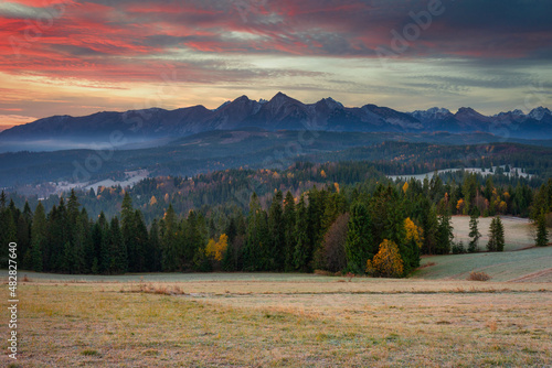 Beautiful sunrise on the meadow under the Tatra Mountains at autumn. Poland photo